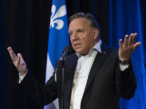 Premier François Legault responds to reporters' questions before entering a pre-session party caucus Thursday, September 9, 2021 in Quebec City.