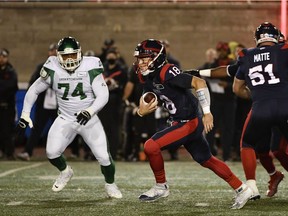 Alouettes quarterback Matthew Shiltz (18) scrambles away from Saskatchewan Roughriders defensive lineman Makana Henry (74) in the first quarter at Molson Field in Montreal on Saturday, Oct. 30, 2021.