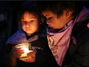 Siblings Stéphanie (left) and Maiden Dubé attend a Montreal vigil on the first anniversary of the death of their aunt Joyce Echaquan. On systemic racism, Premier François Legault "always turns the question inside out," Tom Mulcair writes.