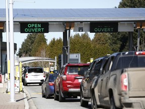 Drivers wait to cross through Canadian customs at the Canada-U.S. border near the Peace Arch Provincial Park in Surrey, B.C.