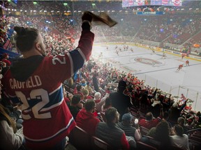 Canadiens fans cheer on the team during pre-game warmup Saturday night at the Bell Centre.