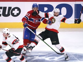 Canadiens' Arber Xhekaj gets a glove in the face as he stops Ottawa Senators' Mark Kastelic during second period preseason NHL action in Montreal on Saturday, Oct. 2, 2021.
