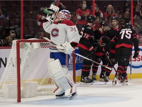 Canadiens goaltender Jake Allen quenches his thirst while Senators players celebrate a second-period goal by Egor Sokolov at the Canadian Tire Centre in Ottawa Friday night.