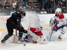 Montreal Canadiens goaltender Jake Allen (34) falls in front of San Jose Sharks centre Andrew Cogliano (11) and Habs' left wing Jonathan Drouin in San Jose.