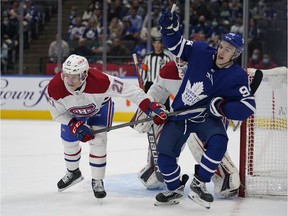 Canadiens defenceman Kaiden Guhle (21) and Maple Leafs forward Kirill Semeyonov (94) battle for position during the first period at Scotiabank Arena in Toronto on Oct. 5, 2021.