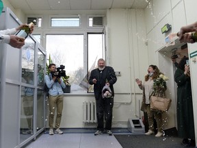 Russian investigative newspaper Novaya Gazeta's editor-in-chief Dmitry Muratov, one of 2021 Nobel Peace Prize winners, is greeted with champagne by editorial staff in Moscow on Friday, Oct. 8, 2021.