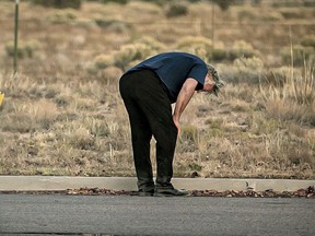 A distraught Alec Baldwin lingers in the parking lot outside the Santa Fe County Sheriff's Office in Santa Fe, N.M., after he was questioned about a shooting on the set of the film Rust on the outskirts of Santa Fe, on Thursday, Oct. 21, 2021. Baldwin fired a prop gun on the set, killing cinematographer Halyna Hutchins and wounding director Joel Souza, officials said.