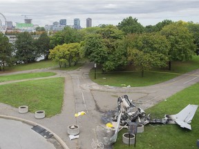 The wreckage of a plane is seen at a crash site in Montreal on Sunday, Oct. 3, 2021. The small plane crashed on Île-Ste-Hélène near Montreal's Old Port on Saturday.