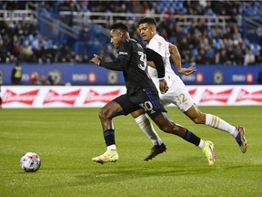 Club de Foot Montréal midfielder Romell Quioto (30) plays the ball against Atlanta United FC defender Miles Robinson (12) during the first half at Stade Saputo on Saturday, Oct. 2, 2021, in Montreal.