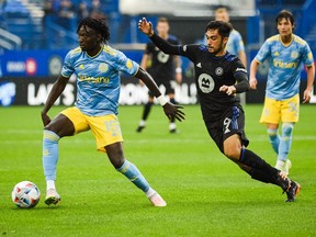 Philadelphia Union defender Olivier Mbaizo (15) plays the ball with CF Montréal midfielder Mathieu Choiniere (29) during the first half at Saputo Stadium in Montreal on Saturday, Oct. 16, 2021.