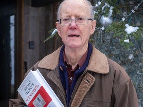Norman Webster in January 2021 with his book Newspapering: 50 Years of Reporting From Canada and Around the World.