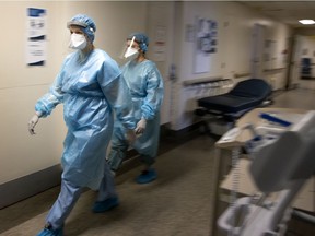 Two nurses do rounds in the COVID-19 unit of the Verdun Hospital in Montreal on Tuesday, Feb. 16, 2021.