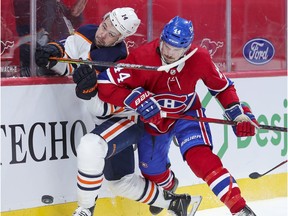 Montreal Canadiens' Joel Edmundson knocks Edmonton Oilers' Devin Shore off the puck during second period in Montreal on May 10, 2021.