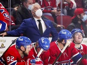 Montreal Canadiens head coach Dominique Ducharme checks the clock while standing behind Jonathan Drouin, left, Christian Dvorak, Josh Anderson and Cole Caufield during third period against the San Jose Sharks in Montreal on Oct. 19, 2021.