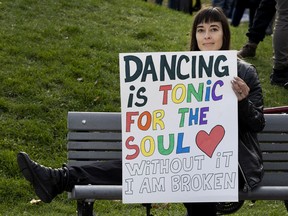 Claire Kenway, aka DJ Claire joins other Montrealers as they take part in a dance to open the dance floors protest in Montreal, on Saturday, Oct. 23, 2021.