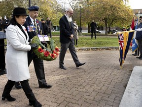 Incumbent mayor Valérie Plante and Stan Kircoff of the Royal Canadian Legion, Branch 4, lay a wreath at a cenotaph as part of an early Remembrance Day event in Verdun on Oct. 28, 2021.