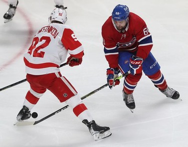 Montreal Canadiens' Alex Belzile slides puck between the legs of Detroit Red Wings' Vladislav Namestnikov during third-period action in Montreal on Tuesday, Nov. 2, 2021.