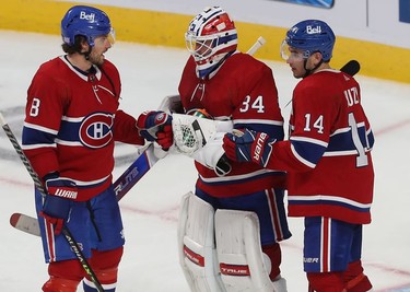 Montreal Canadiens goaltender Jake Allen his congratulated by his teammates Ben Chiarot (8) and Nick Suzuki (14) after getting shutout against the Detroit Red Wings in Montreal on Tuesday, Nov. 2, 2021.
