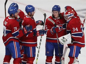 Canadiens players congratulate goalie Jake Allen after he made 22 saves for a shutout in 3-0 win over the Detroit Red Wings Tuesday night at the Bell Centre.