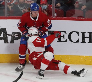 Montreal Canadiens' Christian Dvorak brings down Detroit Red Wings' Robby Fabbri during first-period action in Montreal on Tuesday, Nov. 2, 2021.