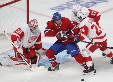 Montreal Canadiens' Christian Dvorak gets close to Detroit Red Wings goaltender Alex Nedeljkovic as Pius Suter (24) and Filip Hronek (17) move in on the play during first-period action in Montreal on Tuesday, Nov. 2, 2021.