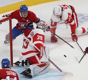 Montreal Canadiens' Brendan Gallagher tries to get onto the loose puck in front of 
Detroit Red Wings goaltender Alex Nedeljkovic and Moritz Seider during first-period action in Montreal on Tuesday, Nov. 2, 2021.