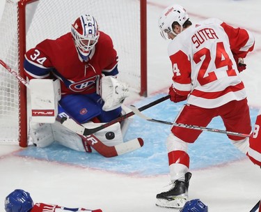 Montreal Canadiens goaltender Jake Allen keeps a close eye on puck with Detroit Red Wings' Pius Suter arriving on the play during second-period action in Montreal on Tuesday, Nov. 2, 2021.