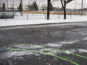 Police markings outline an area where blood stains mark the spot of a stabbing in Marc Aurèle Fortin Park on Thursday, Jan. 2, 2020.