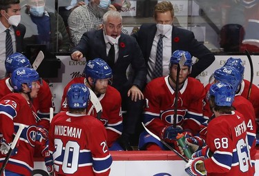 Montreal Canadiens coach Dominique Ducharme speaks to his players during timeout against the New York Islanders during third-period action in Montreal on Thursday, Nov. 4, 2021.