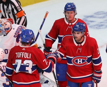 Montreal Canadiens' Tyler Toffoli (73) is congratulated by Montreal Canadiens' Chris Wideman (20) and Christian Dvorak (28) after scoring goal against the New York Islanders during third-period action in Montreal on Thursday, Nov. 4, 2021.