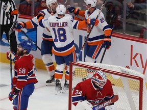 Canadiens defenceman David Savard and goalie Jake Allen react after Islanders players celebrate one of Brock Nelson's second-period goals Thursday night at the Bell Centre.