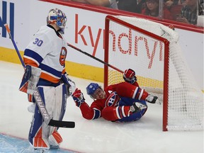 Montreal Canadiens' Brendan Gallagher (11) falls into the net of New York Islanders goaltender Ilya Sorokin during second period NHL action in Montreal on Thursday November 04, 2021.