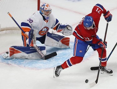 Montreal Canadiens' Jake Evans goes for a backhand shot on New York Islanders goaltender Ilya Sorokin during first-period action in Montreal on Thursday, Nov. 4, 2021.