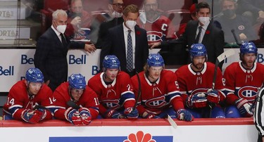Montreal Canadiens coach Dominique Ducharme (far left in mask) and the rest of assistant coaches and members of the team look gloomy following the fifth goal of the New York Islanders during second-period action in Montreal on Thursday, Nov. 4, 2021.