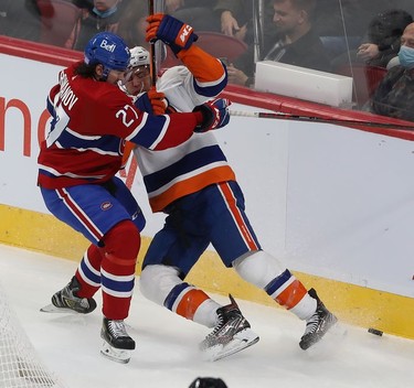 Montreal Canadiens' Alexander Romanov and New York Islanders' Zach Parise during first-period action in Montreal on Thursday, Nov. 4, 2021.