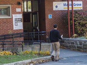 A man heads toward a polling station in the Lachine borough of Montreal on Sunday, November 7, 2021.