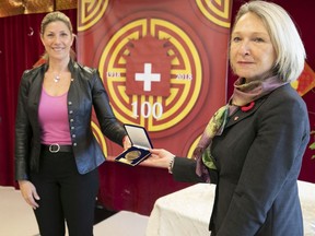 Westmount–Saint-Louis MNA Jennifer Maccarone, left, hands over the National Assembly Medal of Honour to Sonia Bélanger, head of the CIUSSS du Centre-Sud l'Ile-de-Montréal on Monday November 8, 2021 at the Montreal Chinese Hospital.