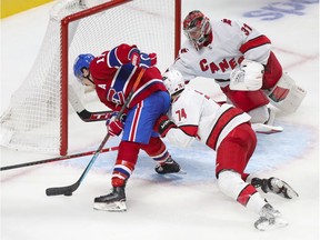 Montreal Canadiens' Brendan Gallagher isn't able to get the puck past Carolina Hurricanes' Jaccob Slavin or goalie Frederik Andersen during third period in Montreal on Oct. 21, 2021.