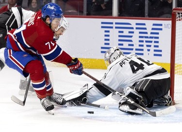 Montreal Canadiens centre Jake Evans (71) fails to get a shot past Los Angeles Kings goaltender Cal Petersen (40) as Los Angeles Kings defenseman Alexander Edler (2) tries to drag him to the ice at the Bell Centre on Tuesday, Nov. 9, 2021.