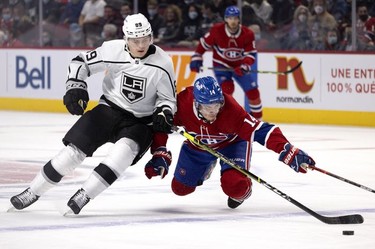Los Angeles Kings centre Rasmus Kupari (89) nudges Montreal Canadiens centre Nick Suzuki (14) to the ice at the Bell Centre on Tuesday, Nov. 9, 2021.