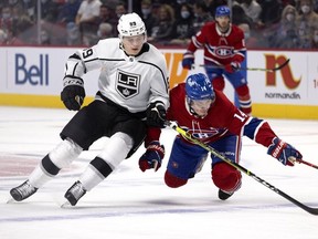 Los Angeles Kings centre Rasmus Kupari (89) nudges Montreal Canadiens centre Nick Suzuki (14) to the ice at the Bell Centre on Tuesday, Nov. 9, 2021.