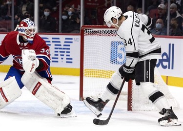 Los Angeles Kings left wing Arthur Kaliyev (34) uses his skate to try to stop a bouncing puck as Montreal Canadiens goaltender Jake Allen (34) looks back in to his crease at the Bell Centre on Tuesday, Nov. 9, 2021.