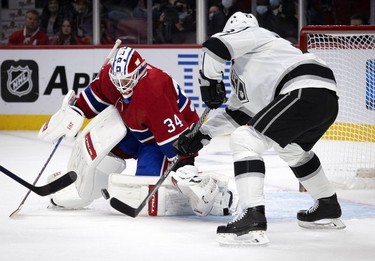 Los Angeles Kings right wing Dustin Brown (23) tries to tip the puck between Montreal Canadiens goaltender Jake Allen's (34) pads at the Bell Centre on Tuesday, Nov. 9, 2021.