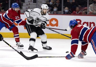 Montreal Canadiens defenseman Jeff Petry (26), left, tries to slow down Los Angeles Kings left wing Phillip Danault (24) as Montreal Canadiens defenseman Ben Chiarot (8) blocks Danault's shot at the Bell Centre on Tuesday, Nov. 9, 2021.