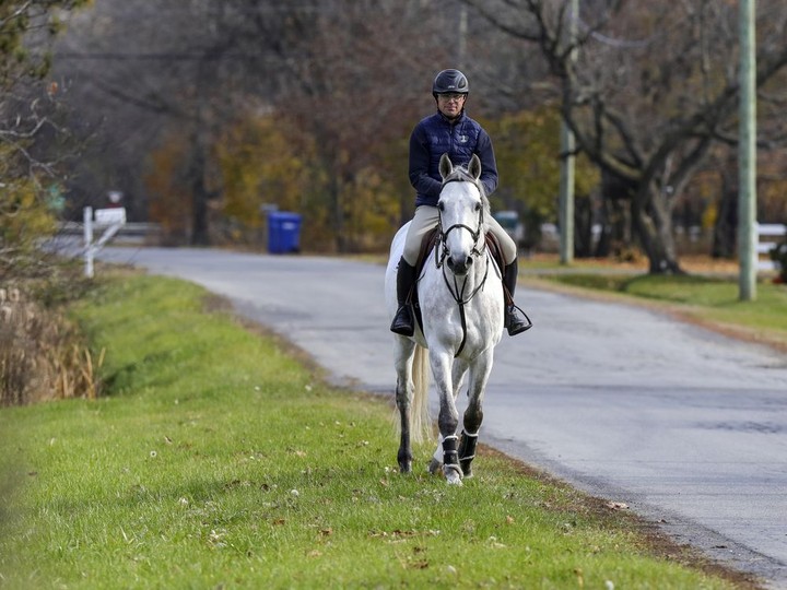  A country moment as Edouard Oger rides Chrome down Park Rd. in Rigaud.