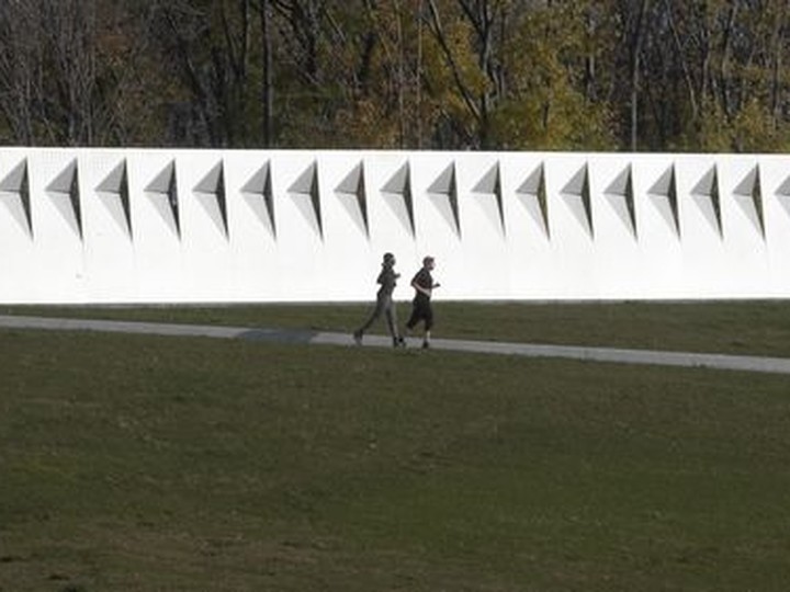  The sound barrier at Jean-Drapeau Park like a white streak against the fall backdrop as joggers run past.