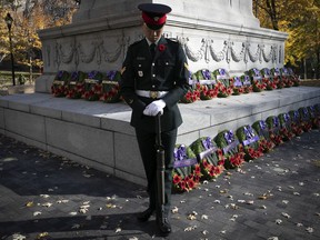 A sentry stands guard at the war memorial in Place du Canada during the Remembrance Day ceremony in Montreal on Thursday November 11, 2021.