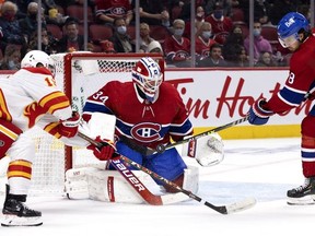 Montreal Canadiens defenseman Ben Chiarot (8) knocks the puck away from Montreal Canadiens goaltender Jake Allen as Calgary Flames left wing Matthew Tkachuk (19) looks for a rebound during 2nd-period NHL action in Montreal on Thursday, Nov. 11, 2021.