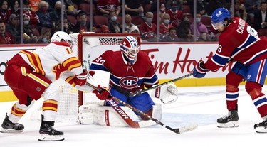 Montreal Canadiens defenseman Ben Chiarot (8) knocks the puck away from Montreal Canadiens goaltender Jake Allen as Calgary Flames left wing Matthew Tkachuk (19) looks for a rebound during 2nd-period NHL action in Montreal on Thursday, Nov. 11, 2021.