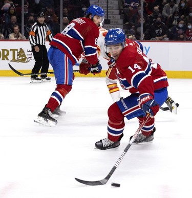 Montreal Canadiens defenseman Ben Chiarot (8), rear, checks on Montreal Canadiens centre Nick Suzuki (14) as he gets control of the puck during 2nd-period NHL action in Montreal on Thursday, Nov. 11, 2021.